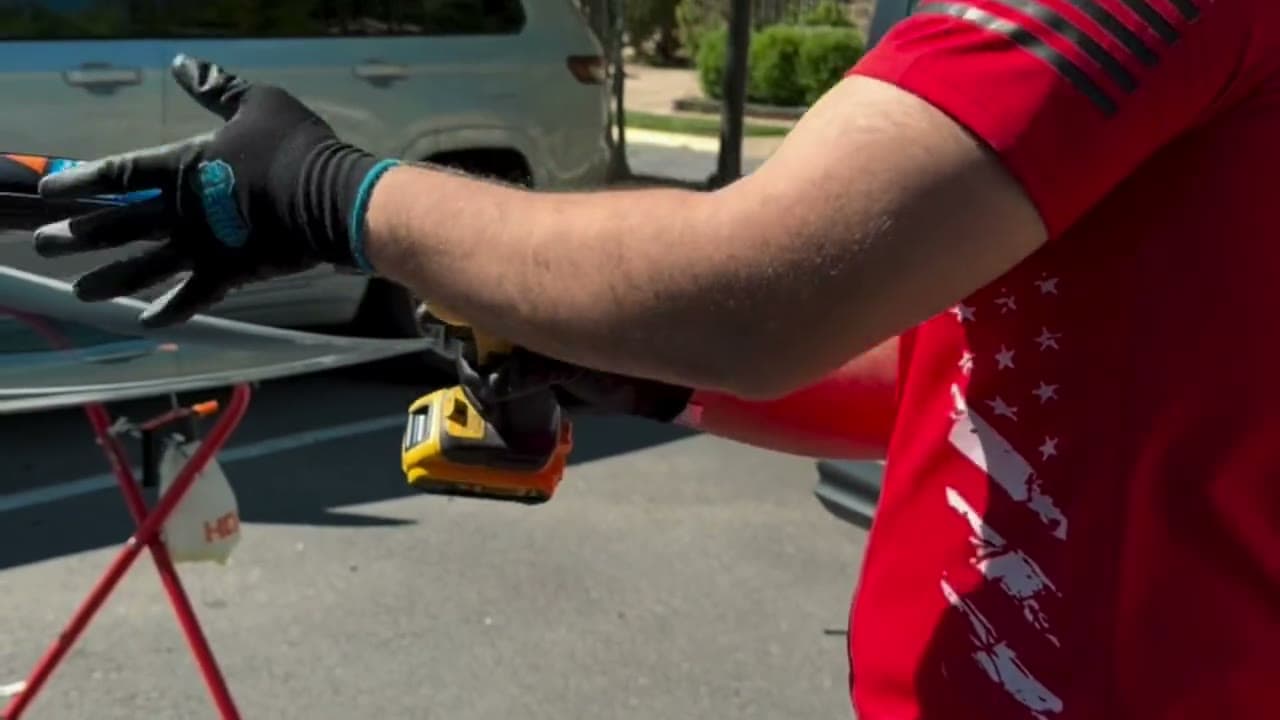 VA Auto Glass technicians setting a new windshield into a car in Northern Virginia