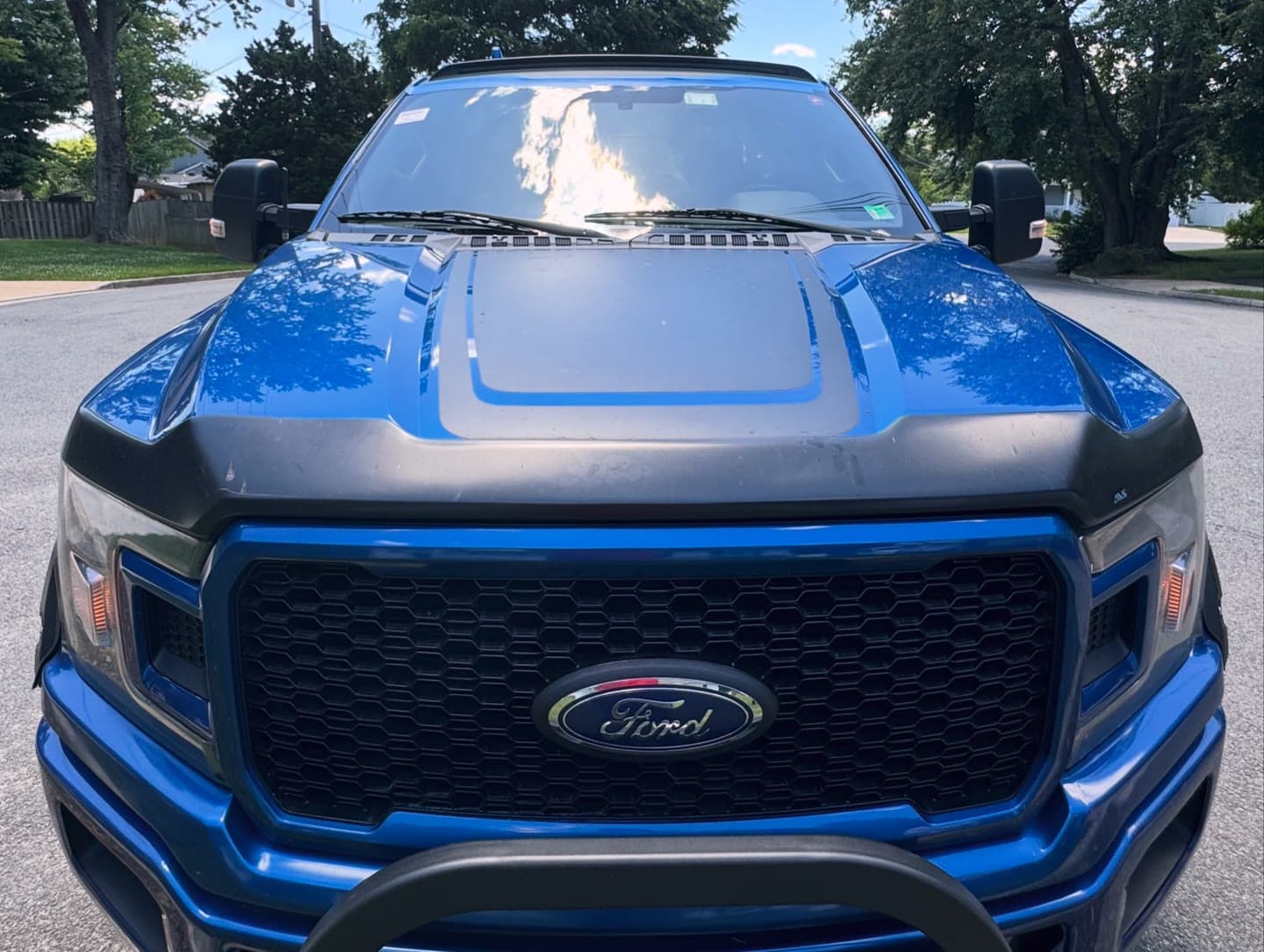 Windshield replacement on a blue Ford F-150, old glass out and OEM-quality glass installed