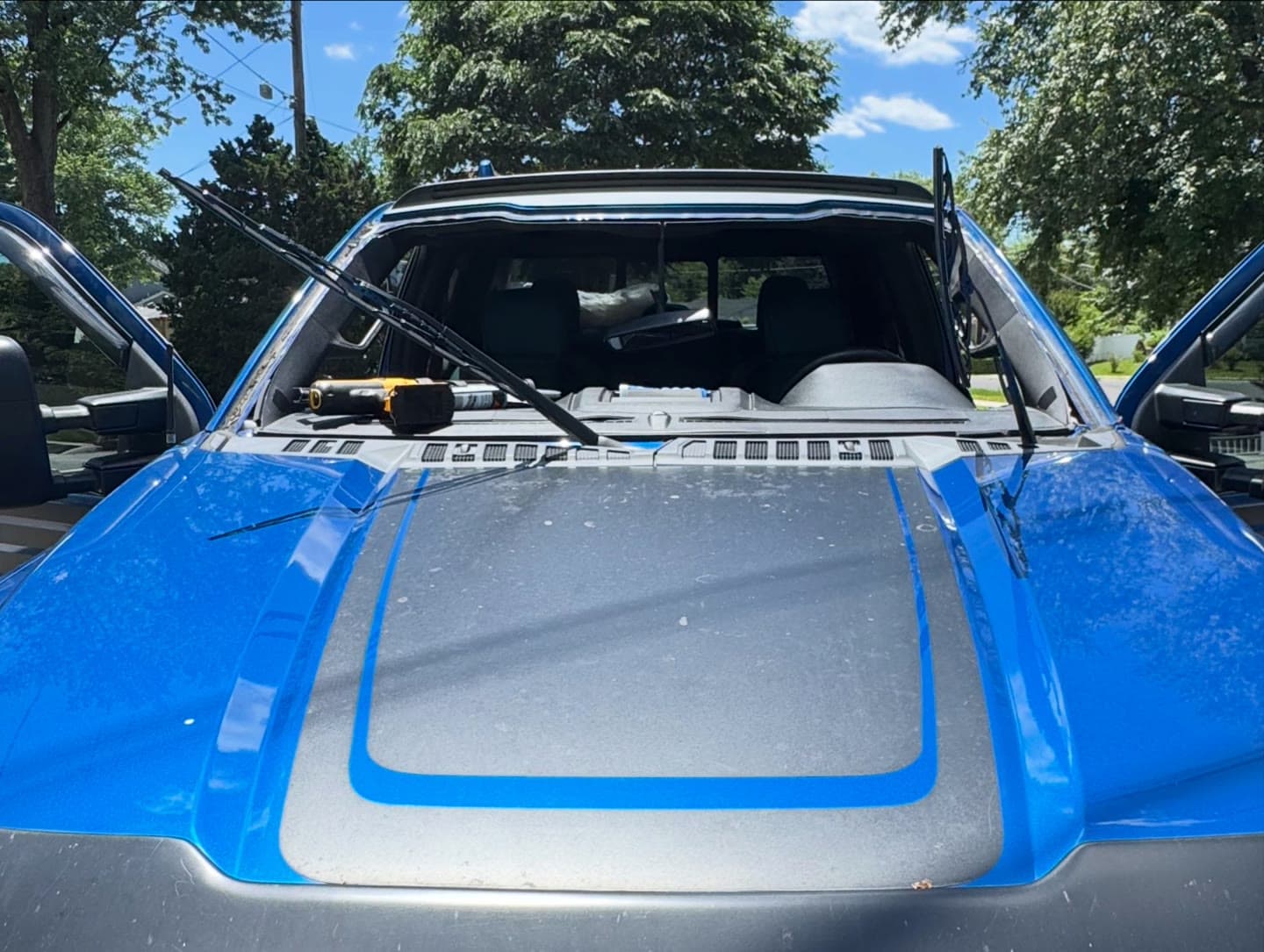 Windshield replacement on a blue Ford F-150, old glass out and OEM-quality glass installed