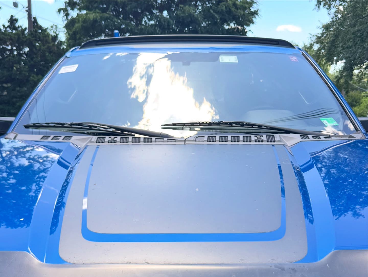 Windshield replacement on a blue Ford F-150, old glass out and OEM-quality glass installed